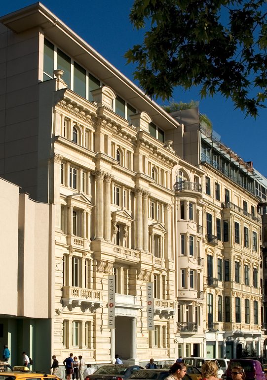 The ornate pale stone façade of Pera Museum viewed from the street.