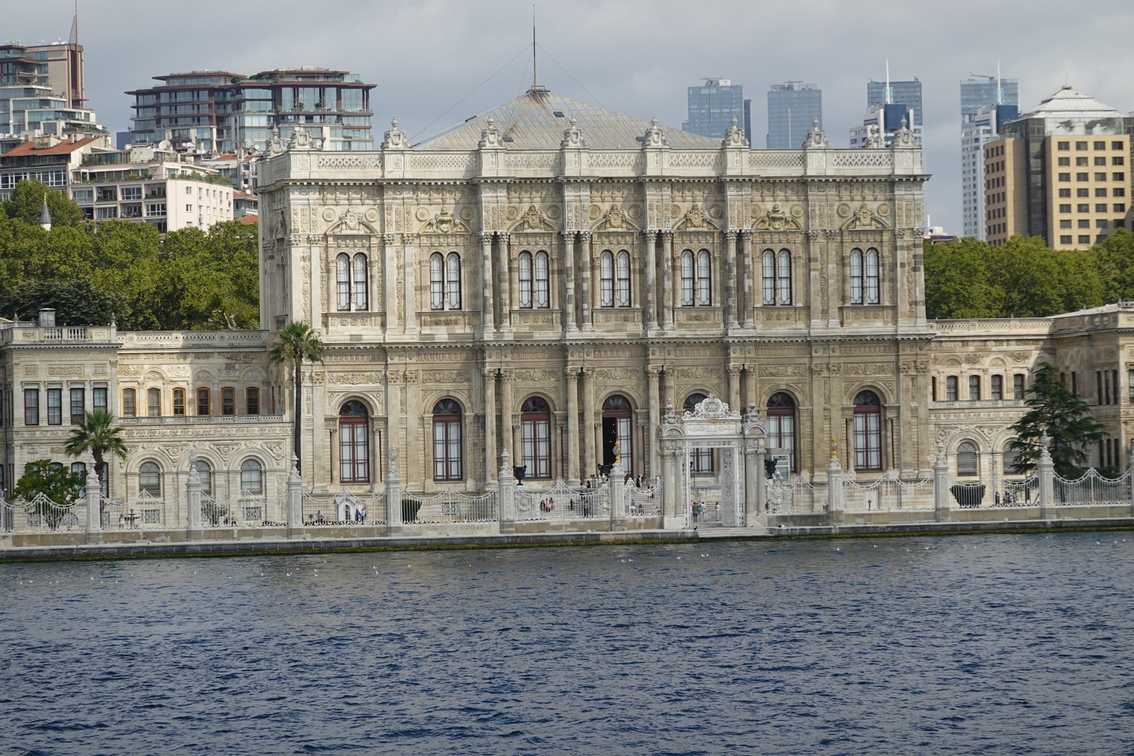 Dolmabahçe’s ornamented Bosphorus façade, photographed from the water in August 2026.