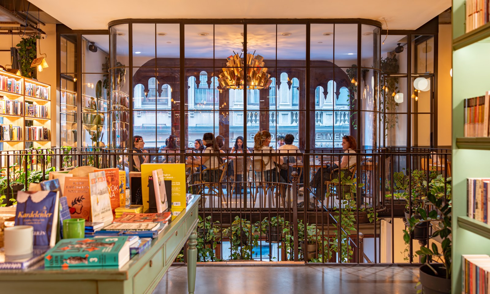 Books and café seating inside Minoa Pera, photographed in May 2025.