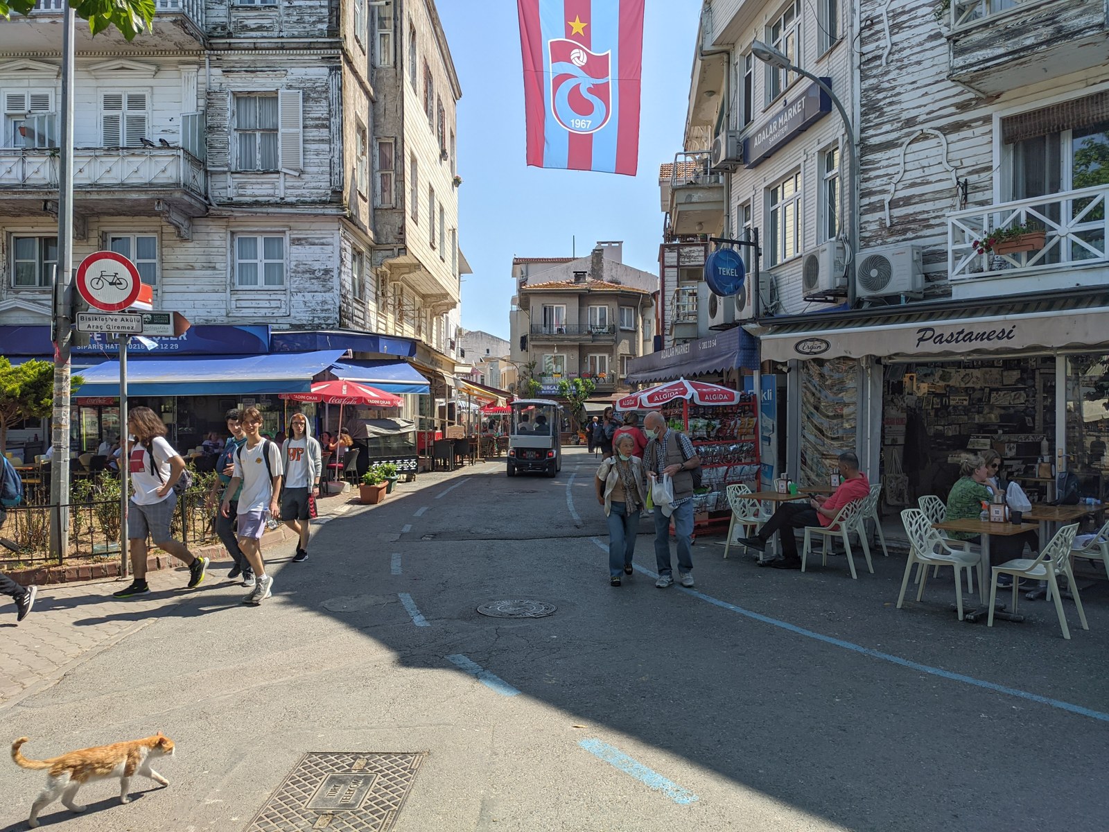 A café-lined street near Burgazada’s ferry pier, May 2022.